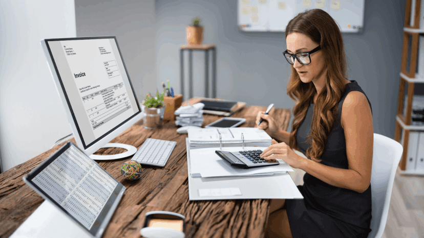 Accountant Calculating Tax At Desk