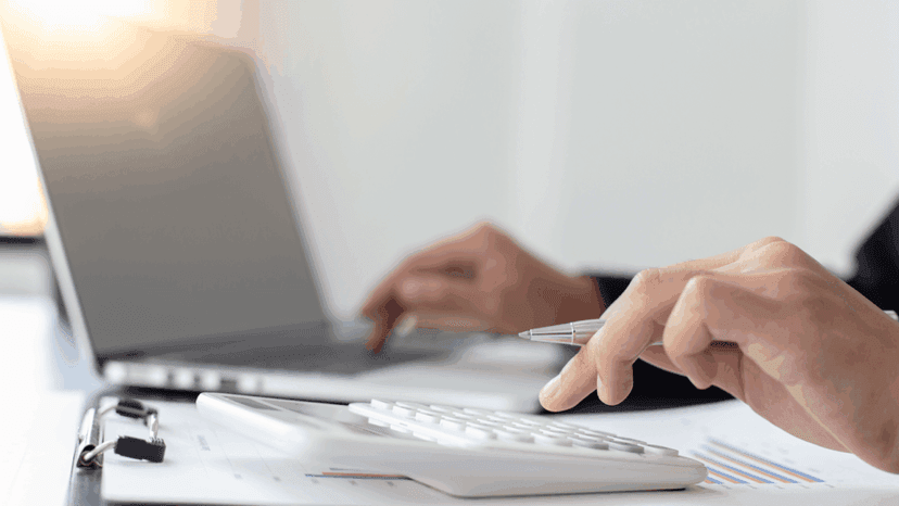 Accountant Typing on a Laptop and Calculator