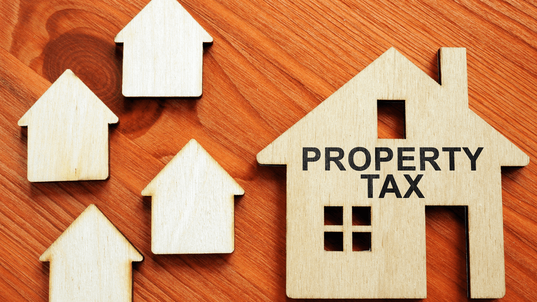 Wooden house figures representing property tax